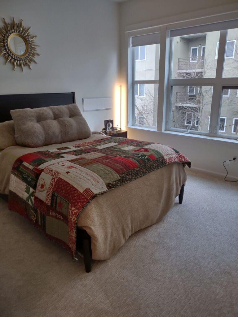 A clean bedroom with nice carpeting and bed linens to show bedroom cleaning services